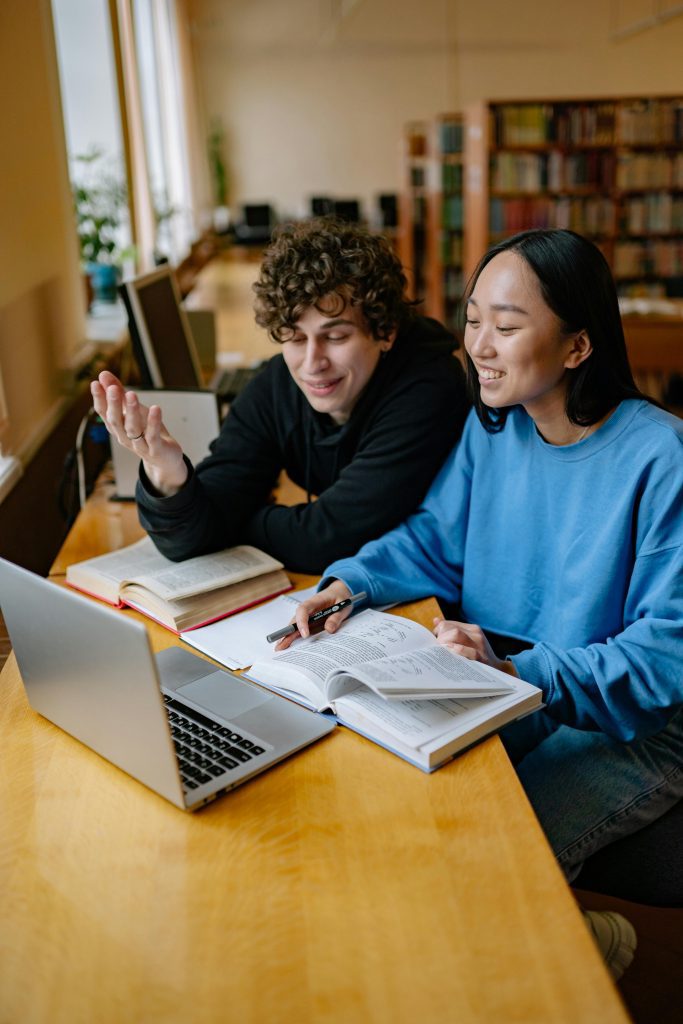 a man and a woman celebrating finishing a thesis paper
